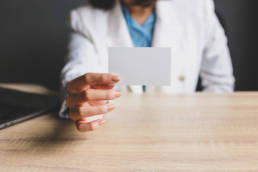 woman showing blank name card