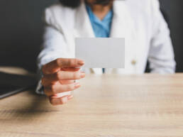 woman showing blank name card